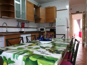 a kitchen with a table with a table cloth on it at Discovery Apartment Benfica in Lisbon