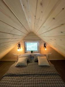 a large bed in a small room with a window at Cozyhouse in Slavske
