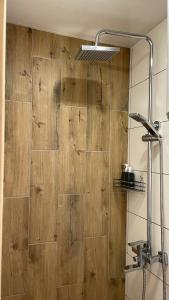 a bathroom with a shower with a wooden wall at Cozyhouse in Slavske +37 photos