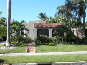 a house with palm trees in front of it at Case de León from the 1920's is a piece of Floridas relaxing history in West Palm Beach