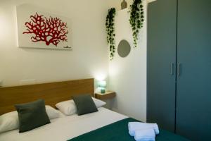 a bedroom with a bed and a red painting on the wall at Casa Corallium in Torre del Greco