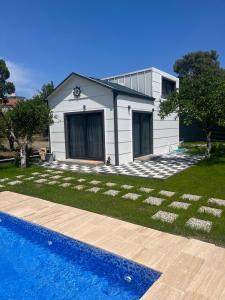 a house and a swimming pool in front of a house at Sea Life Homes in Kemer