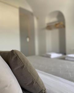 a close up of a bed in a room at Arco Bianco Suites in Akrotiri