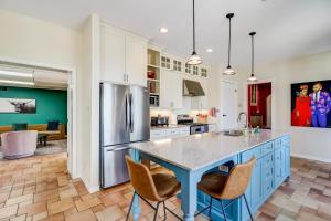 a kitchen with a blue island in the middle at Casa Alegre in San Antonio
