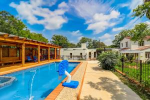 a swimming pool with a blue pool toy in a backyard at Casa Alegre in San Antonio