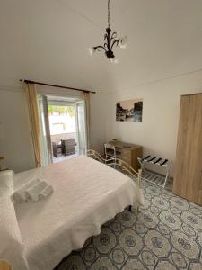 a bedroom with a white bed and a window at Capri Pride Guest House in Capri