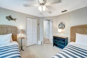 a bedroom with two beds and a ceiling fan at Ocean View Villa in Holmes Beach