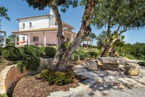 a house with a tree in front of it at VILLA MONTE PARDAL w/ Heated Pool in Natural Park in Moncarapacho