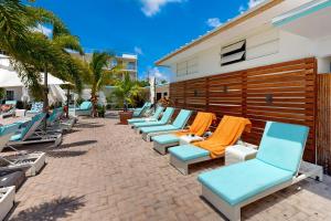 a row of chaise lounge chairs on a patio at Skipjack Resort & Marina #404 in Marathon