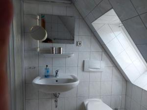 a bathroom with a sink and a toilet at Pension Schwark in Bad Doberan