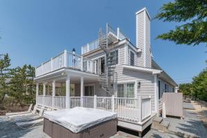 a white house with a deck and a balcony at Beach House in Amagansett