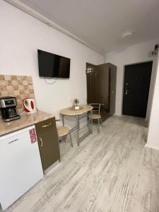 a room with a kitchen and a table with a tablektop at Garsoniera la Mare in Saturn +5 photos