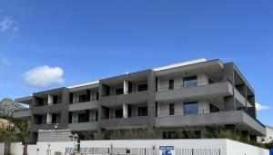 an apartment building with a blue sky in the background at Hotel Crystal in Orebić