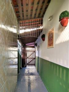 a hallway of a building with a green wall at Pousada Primeira Quadra Da Praia in Praia Grande