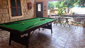 a pool table sitting on a tile floor in a patio at Paradise Rabab Apartment & Guesthouse in Haifa