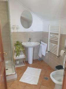 a bathroom with a sink and a mirror at Casa Maria in Negreşti-Oaş