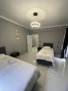 a hotel room with two beds and a light at Continental Trabzon Suite&Apartments in Trabzon