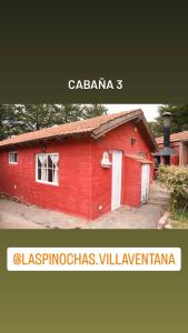 a red building with the words calgarias vlezlezlezlezlezlez at Complejo Las Pinochas in Villa Ventana