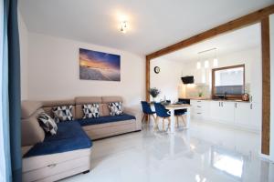 a living room with a couch and a table at Domki Lilia Sarbinowo in Sarbinowo