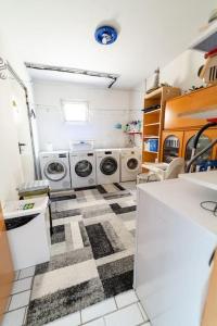 a laundry room with two washer and dryers in it at Einzigartiger Panoramablick zur Schwäbische Alb 
