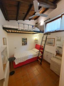 a room with a bunk bed and a ladder at Poggiolindo B&B in Capodimonte