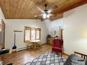 a living room with a ceiling fan and a table at Ponderosa A in Woodland Park