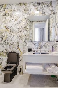 a bathroom with a white sink and a mirror at Blue Sea Karpasia Hotel in Rizokarpaso +66 photos