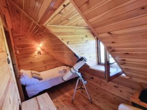 a camera in a wooden room with a attic at Dom na Mazurach - Willa pod Jaworem in Olsztynek