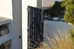 a black gate on the side of a house at Spilia Retreat in Kamarai