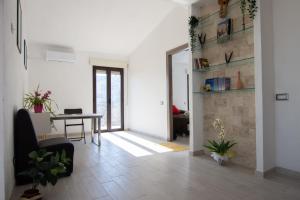 een woonkamer met een tafel en een stoel bij La Finestra Sul Mare in Lanusei