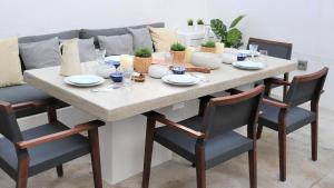 a dining room table with chairs and a couch at Spilia Retreat in Kamares