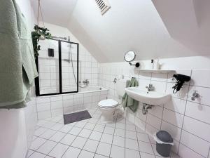 a white bathroom with a sink and a toilet at Apartment Scandic Living in Bautzen