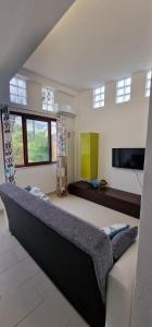 a large bedroom with a large bed and a flat screen tv at CASA CASCIOTTO in Palermo