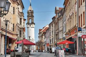 a city street with a clock tower in the distance at Apartment Scandic Living in Bautzen