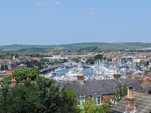 a view of a harbor with boats in a city at North Harbour House in Weymouth