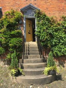 a set of stairs leading to a yellow door at The Old Stores in Montgomery