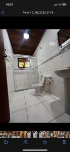a bathroom with a toilet and a sink at toda paz do universo in Nova Friburgo