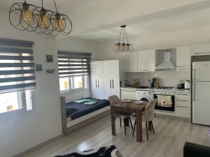 a kitchen with a table and a dining room at New studio no2 in the middle off famagusta & NETFLIX in Famagusta