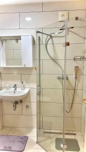a bathroom with a shower and a sink at Apartments Neven in Omiš