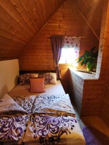 a bedroom with a bed in a wooden cabin at Pension Treissmann in Pichling bei Stainz