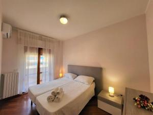 a bedroom with a bed with two towels on it at Appartamenti Orchidea in Tropea
