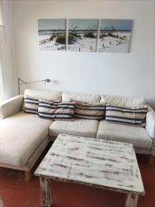 a living room with a couch and a coffee table at Caños de Meca Apartamento frente al mar in Los Caños de Meca