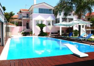 a swimming pool in front of a house at Queen Boutique Suites Preveza in Preveza