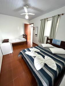 um quarto com uma cama grande com riscas brancas e azuis em Pousada do Genesio em Petrópolis