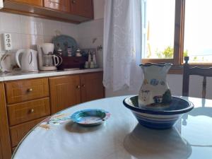 a vase sitting on a table in a kitchen at Aglaia's traditional house in Ayía Kiriakí