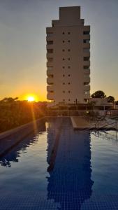 a hotel with a pool in front of a building at Now Alto Da Boa Vista in São Paulo