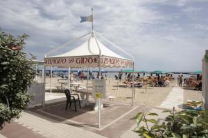 a gazebo on the beach with a crowd of people at Hotel Euro in Bellaria-Igea Marina