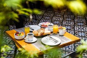 a table topped with plates of food and drinks at Rugendas Hotel Boutique by Time Hotel & Apartments in Santiago