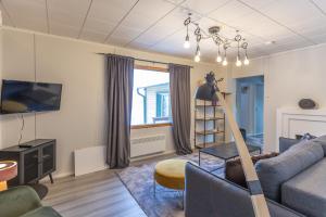 a living room with a couch and a table at Kuukkeli Ivalo Arctic House in Ivalo