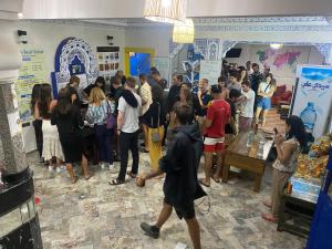 a crowd of people standing in a room at Essaouira Beach Hostel in Essaouira